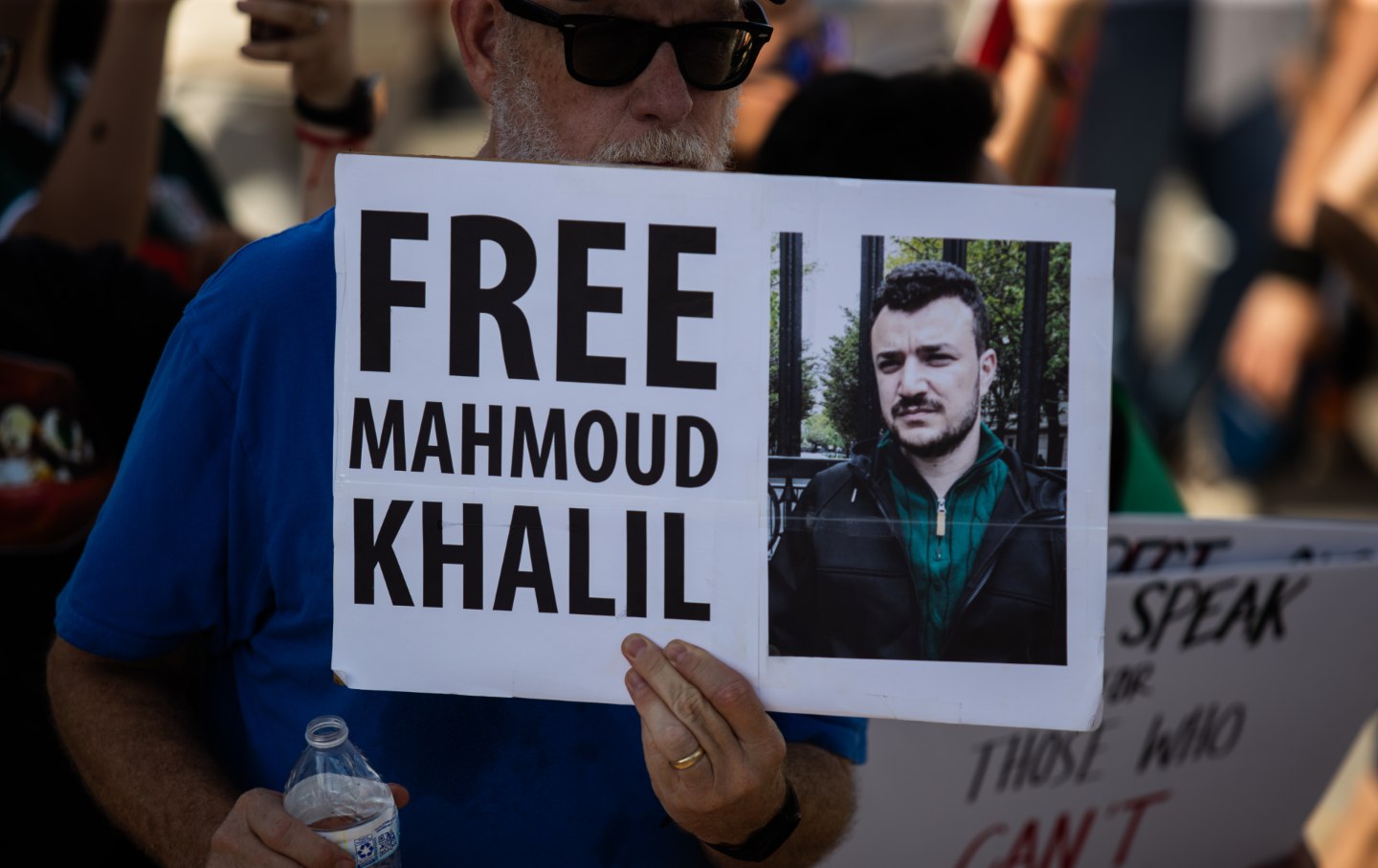 A protester holds a sign that reads, ''Free Mahmoud Khalil.''